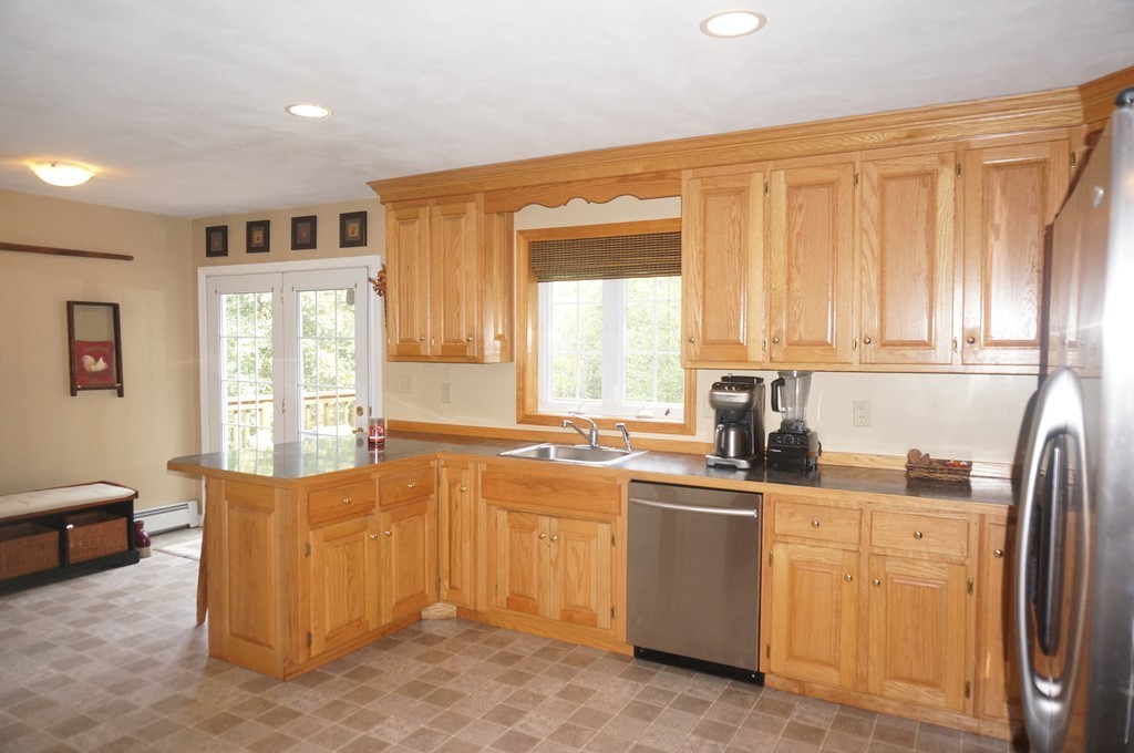 34 Turner Road Townsend, MA 01469 - Photo 10 of 21 a kitchen with stainless steel appliances granite countertop a refrigerator a sink a stove with white cabinets