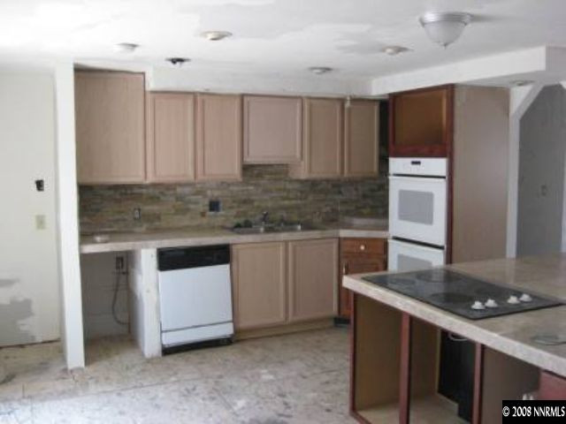 1770 West 6th Street Reno, NV 89503 - Photo 3 of 4 a kitchen with stainless steel appliances granite countertop a stove a sink and a refrigerator