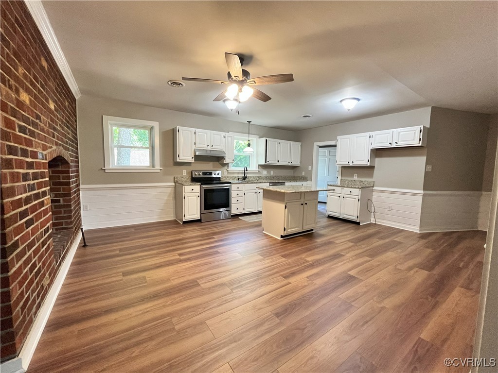 12027 Old Buckingham Road Midlothian, VA 23113 - Photo 11 of 40 a view of a kitchen with wooden floor and stainless steel appliances