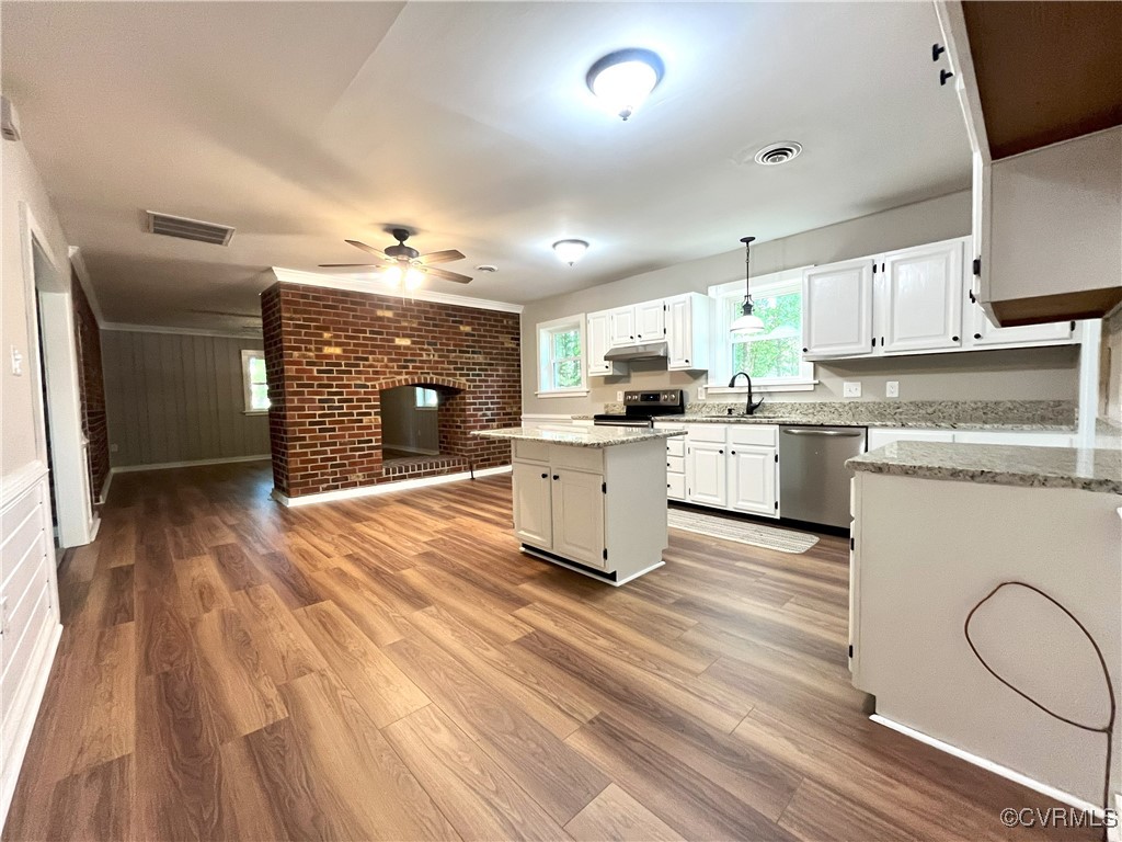 12027 Old Buckingham Road Midlothian, VA 23113 - Photo 12 of 40 a large kitchen with stainless steel appliances granite countertop a stove a sink dishwasher and white cabinets with wooden floor