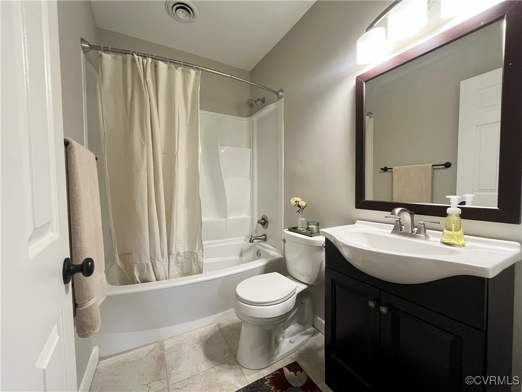 12027 Old Buckingham Road Midlothian, VA 23113 - Photo 21 of 40 a bathroom with a sink a toilet and a mirror