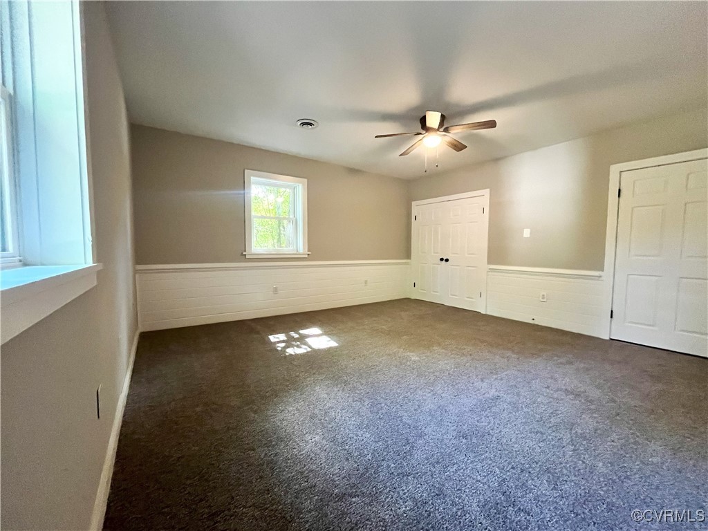 12027 Old Buckingham Road Midlothian, VA 23113 - Photo 28 of 40 an empty room with chandelier fan and windows