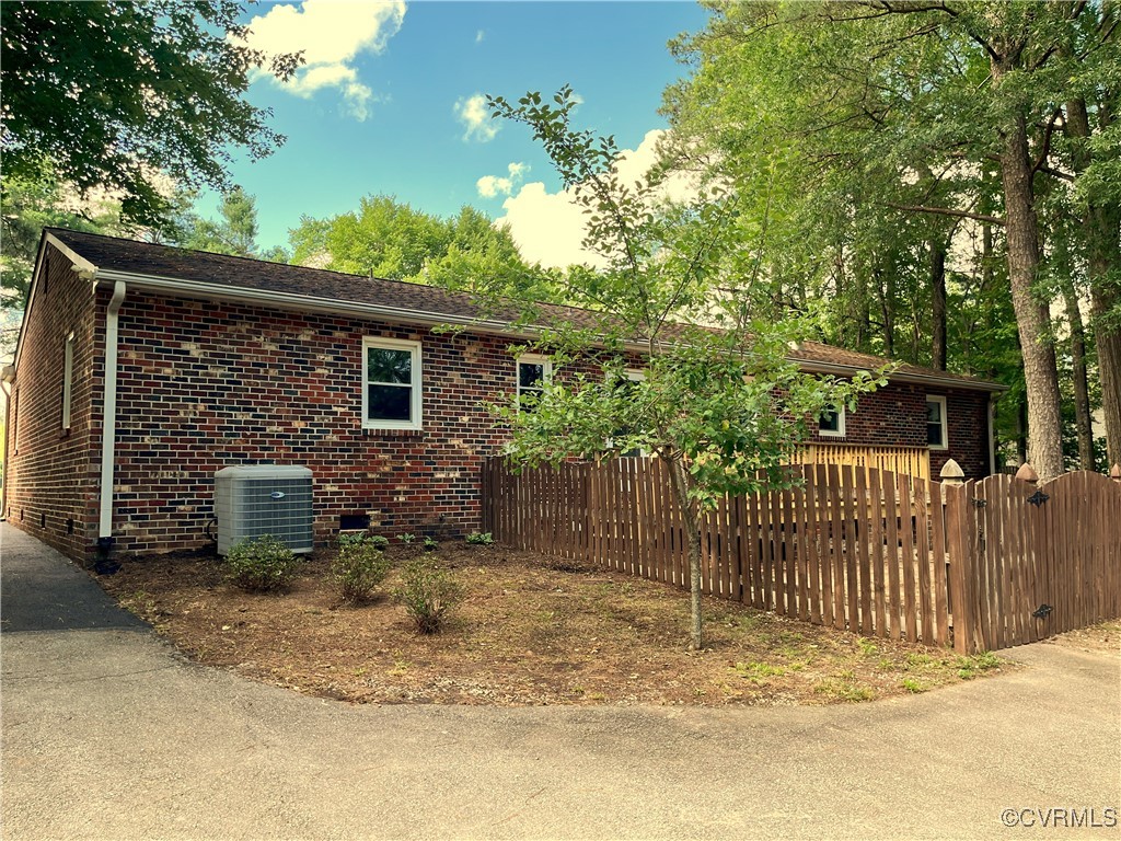 12027 Old Buckingham Road Midlothian, VA 23113 - Photo 37 of 40 a view of a house with a wooden fence
