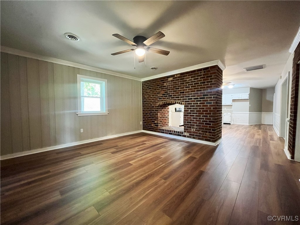 12027 Old Buckingham Road Midlothian, VA 23113 - Photo 8 of 40 an empty room with wooden floor fireplace and windows