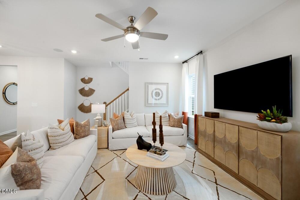 717 Bolera Road Knightdale, NC 27545 - Photo 12 of 43 a living room with furniture and a flat screen tv