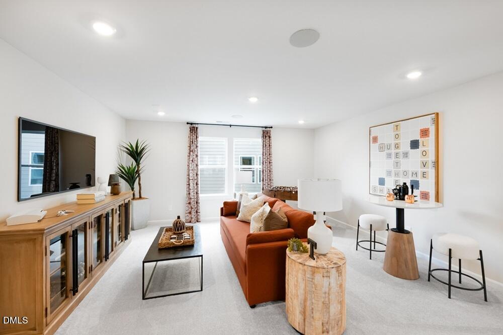 717 Bolera Road Knightdale, NC 27545 - Photo 18 of 43 a living room with furniture and a flat screen tv