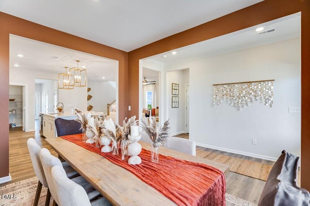 717 Bolera Road Knightdale, NC 27545 - Photo 8 of 43 a view of a dining room with furniture and wooden floor