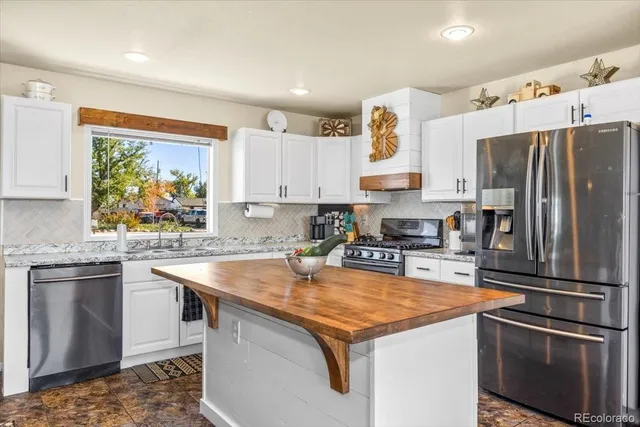 a living room with furniture and kitchen view