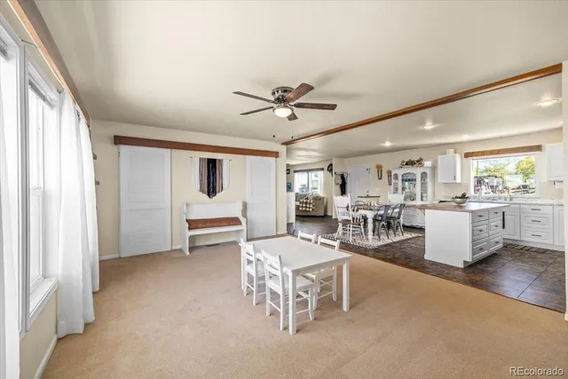 a spacious bedroom with a bed a couch and a large window