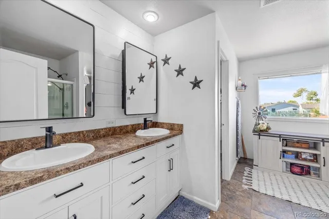 a bedroom with two beds and a window