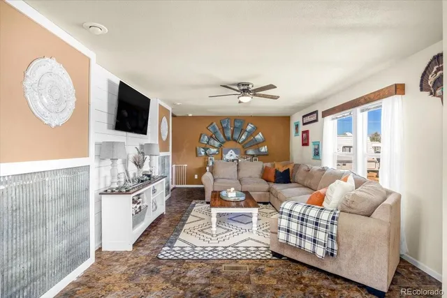a living room with furniture a rug and a flat screen tv