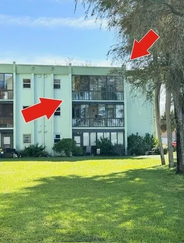 a balcony with wooden floor and lake view