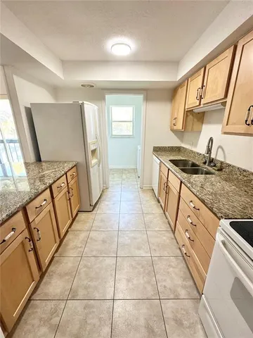 a kitchen with a stove top oven sink and cabinets