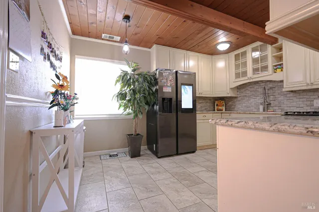 a kitchen with stainless steel appliances granite countertop a stove sink and cabinets