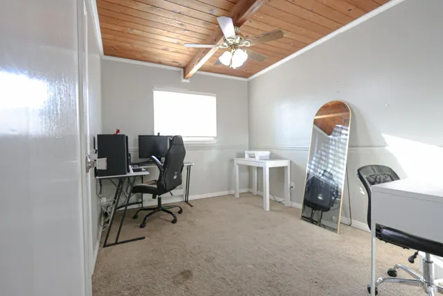 a view of a house with a yard and large tree