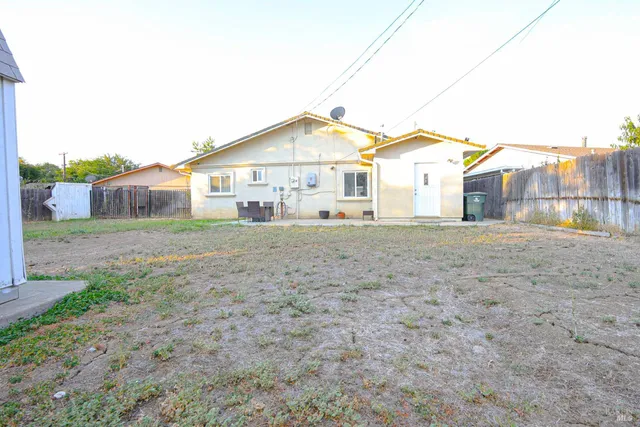 a view of a house with a backyard