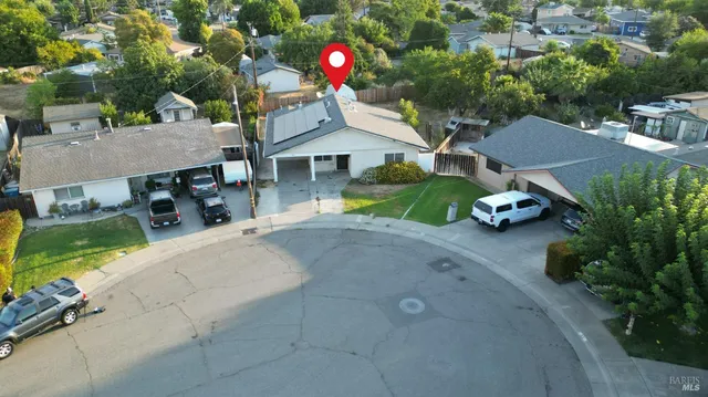 an aerial view of a house with yard