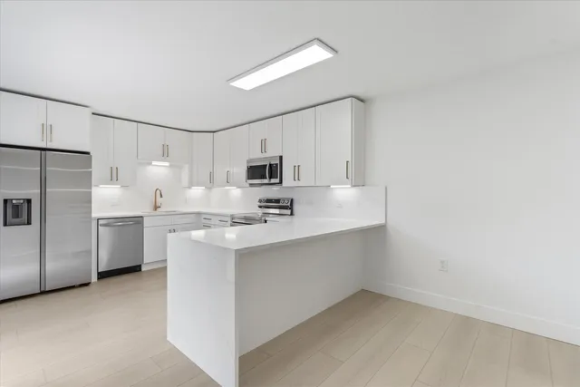 a kitchen with appliances cabinets and a sink
