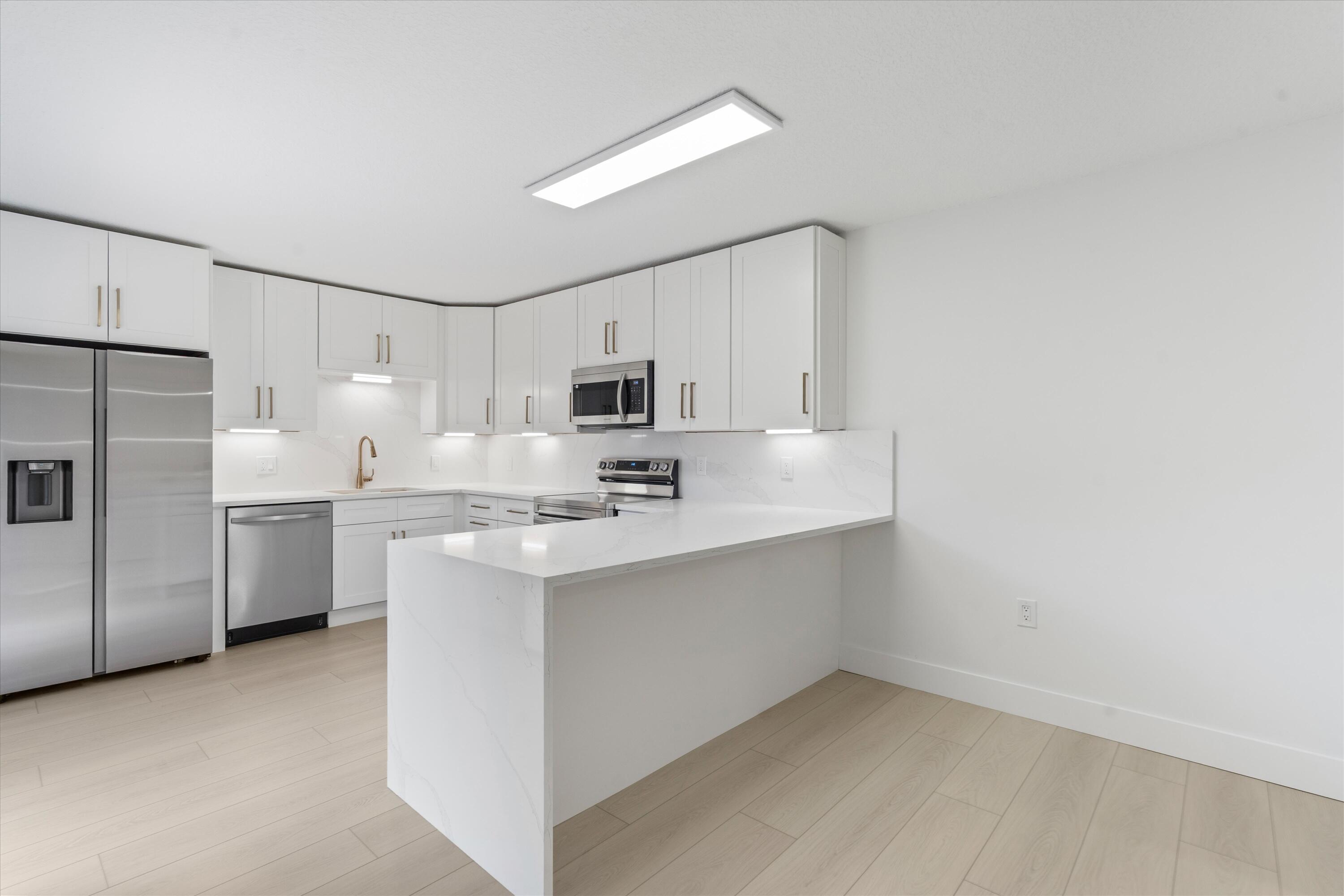 a kitchen with appliances cabinets and a sink