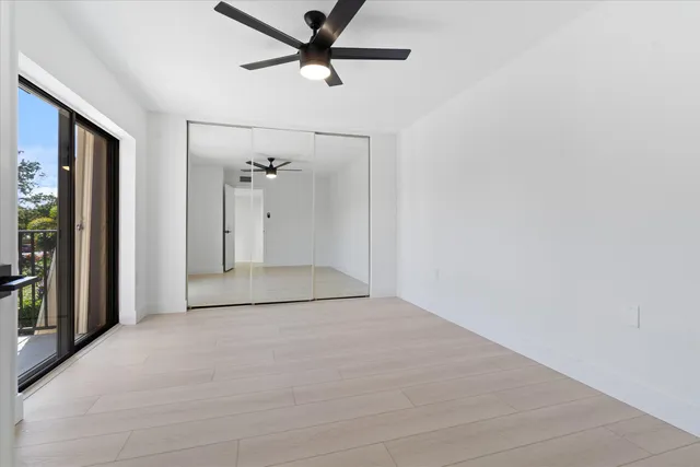 an empty room with chandelier fan