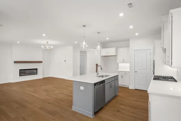 a kitchen with stainless steel appliances granite countertop a sink a stove and a refrigerator