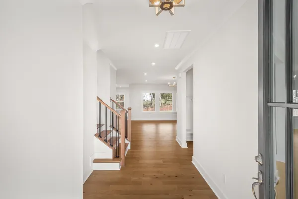 a view of entryway and hall with wooden floor