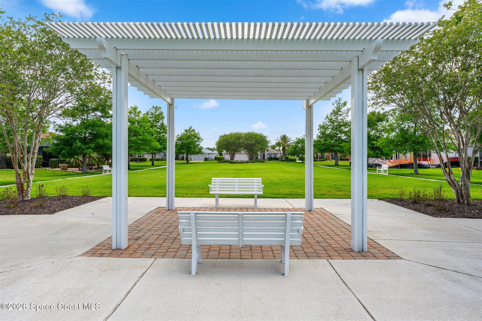 6904 Renshaw Drive Melbourne, FL 32940 - Photo 34 of 46 a view of a patio with a garden