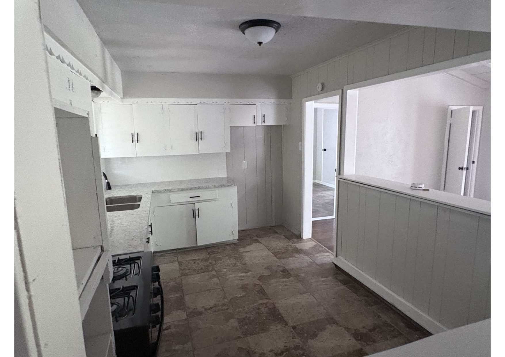 5923 Van Fleet Street Houston, TX 77033 - Photo 12 of 23 a view of a kitchen with refrigerator and white cabinets