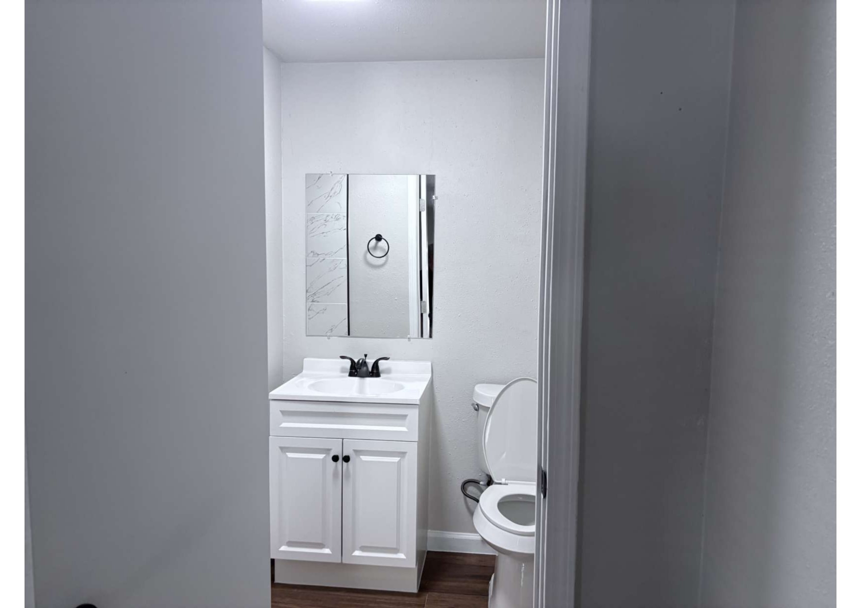 5923 Van Fleet Street Houston, TX 77033 - Photo 13 of 23 a bathroom with a toilet sink and mirror