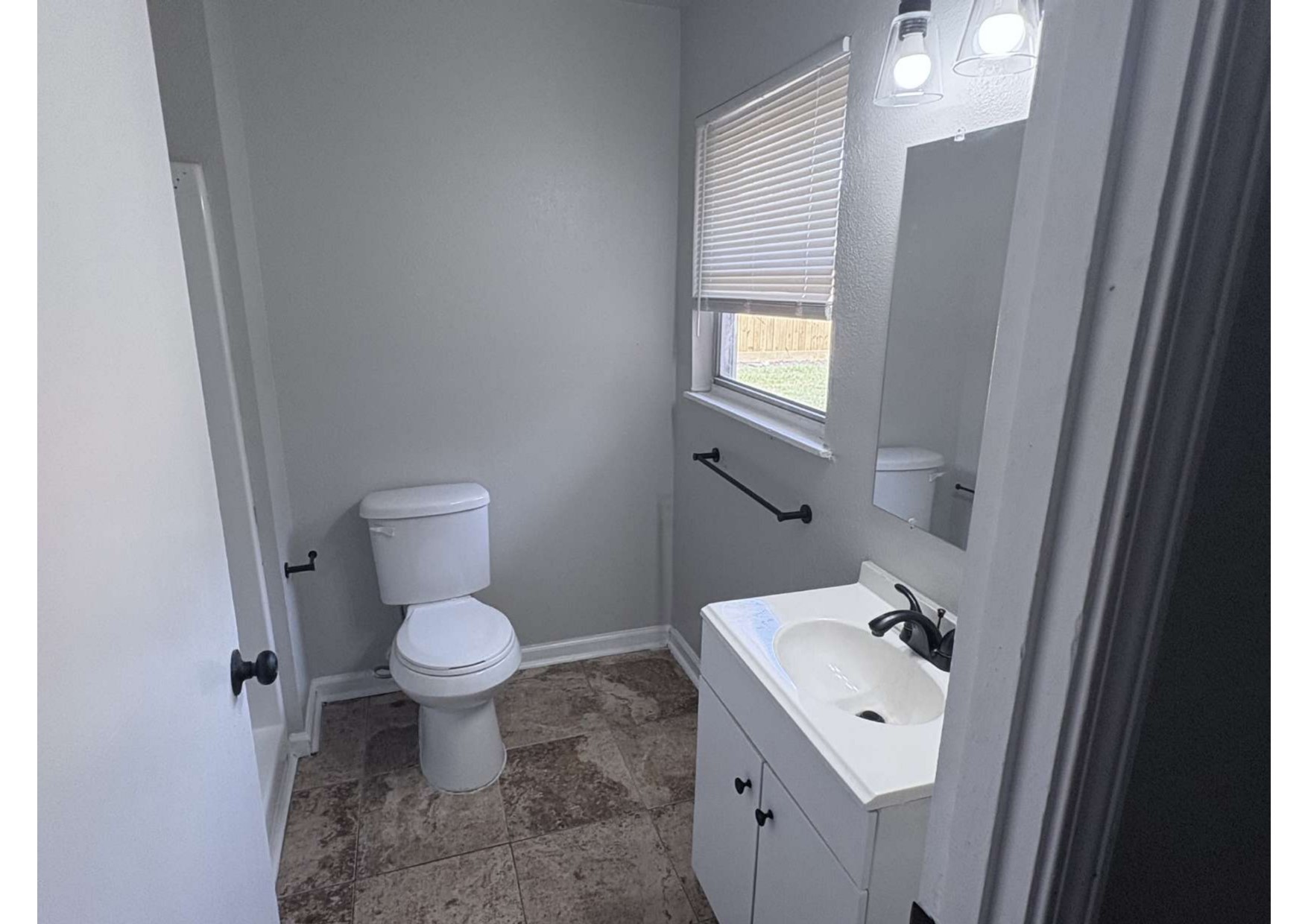 5923 Van Fleet Street Houston, TX 77033 - Photo 18 of 23 a bathroom with a sink toilet and a mirror