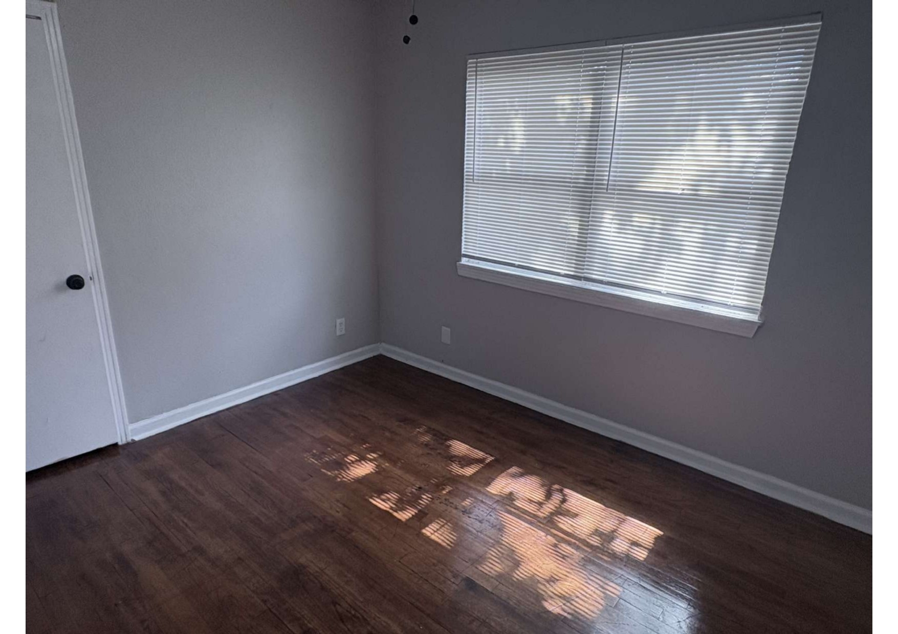 5923 Van Fleet Street Houston, TX 77033 - Photo 20 of 23 an empty room with wooden floor and windows
