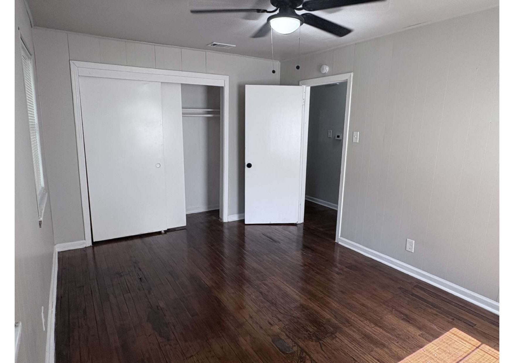 5923 Van Fleet Street Houston, TX 77033 - Photo 23 of 23 an empty room with wooden floor and ceiling fan