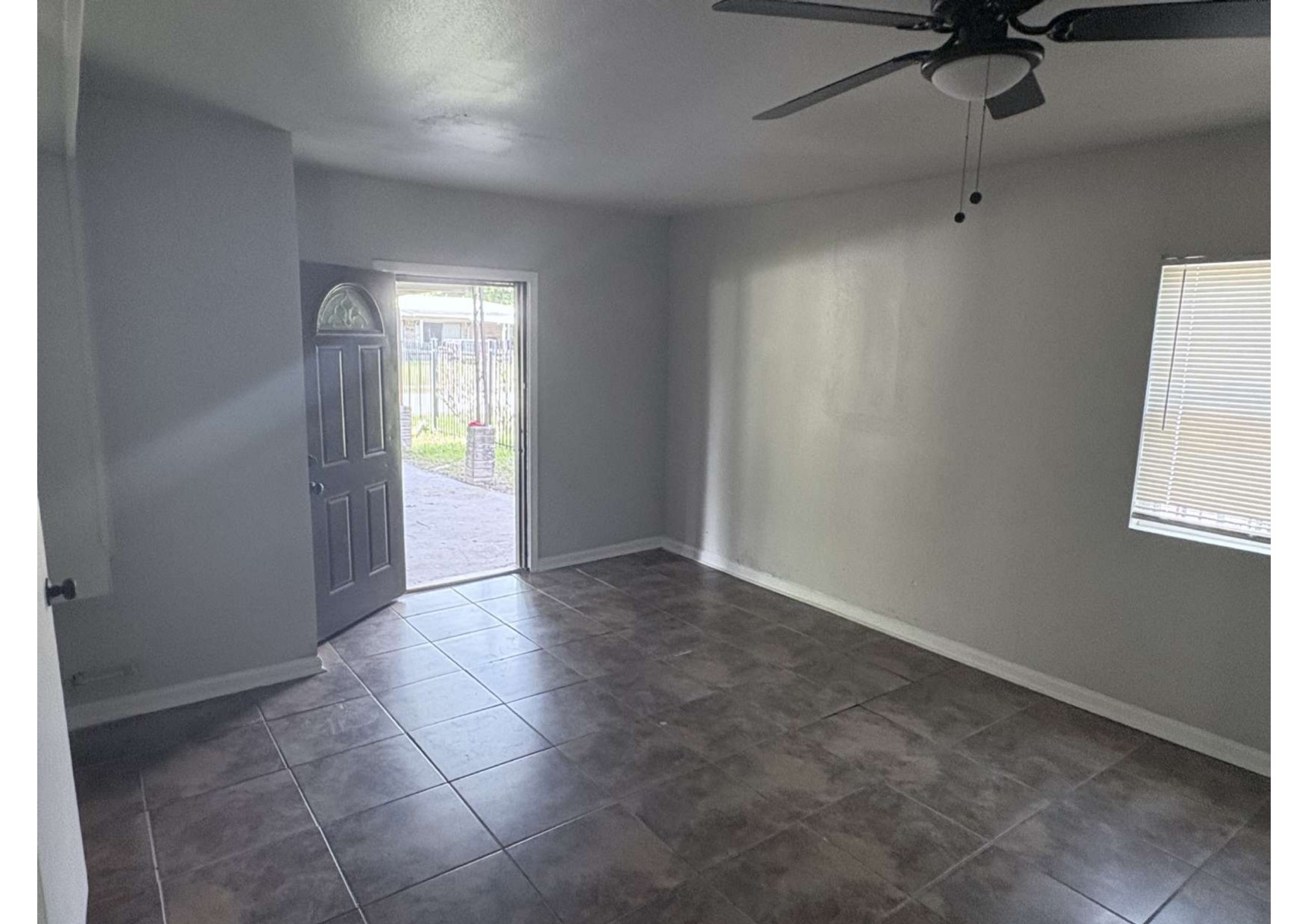 5923 Van Fleet Street Houston, TX 77033 - Photo 8 of 23 an empty room with windows and fan