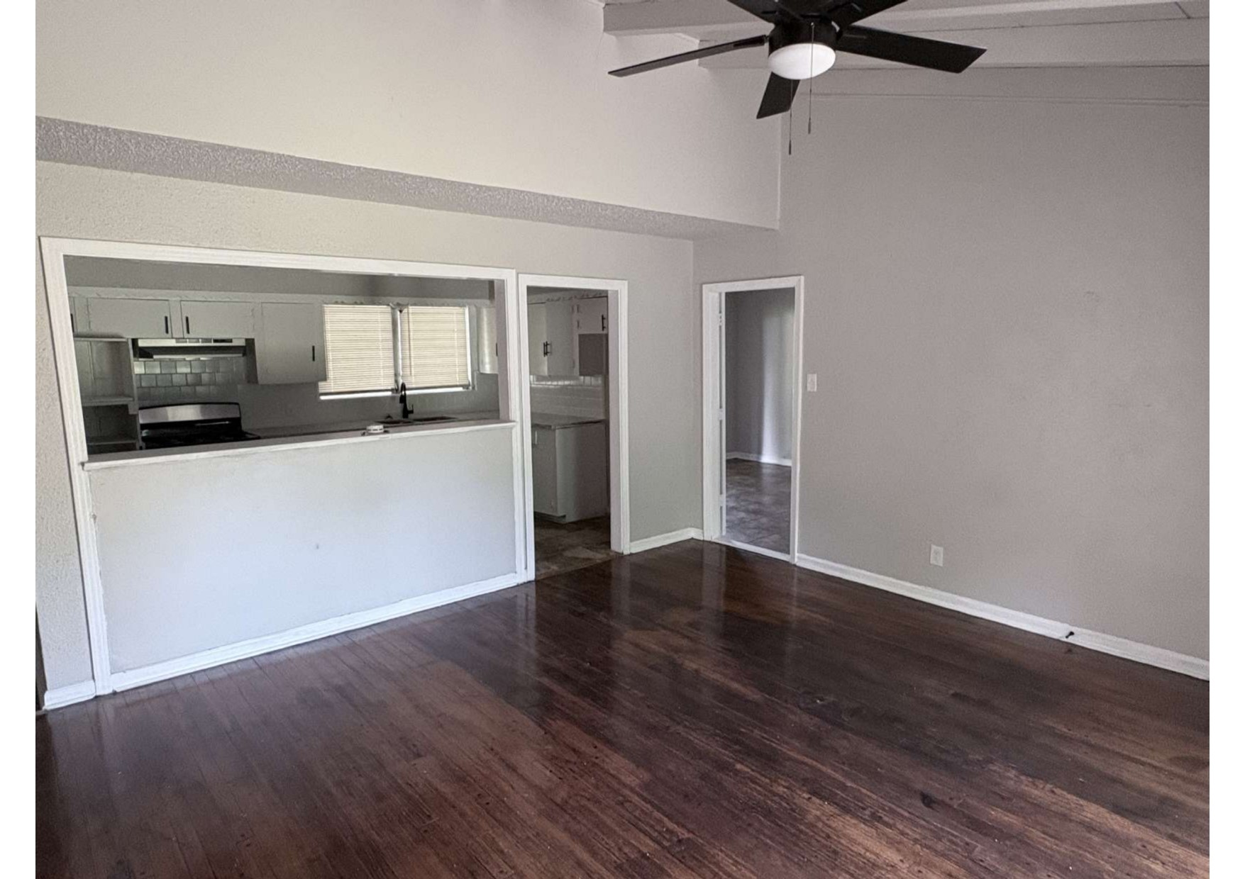 5923 Van Fleet Street Houston, TX 77033 - Photo 10 of 23 a view of a kitchen with a sink cabinet a ceiling fan and hardwood floor