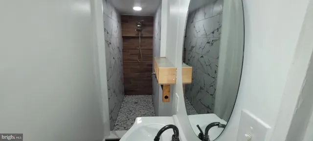 a bathroom with a shower and a sink