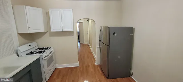 a kitchen with a refrigerator and a stove