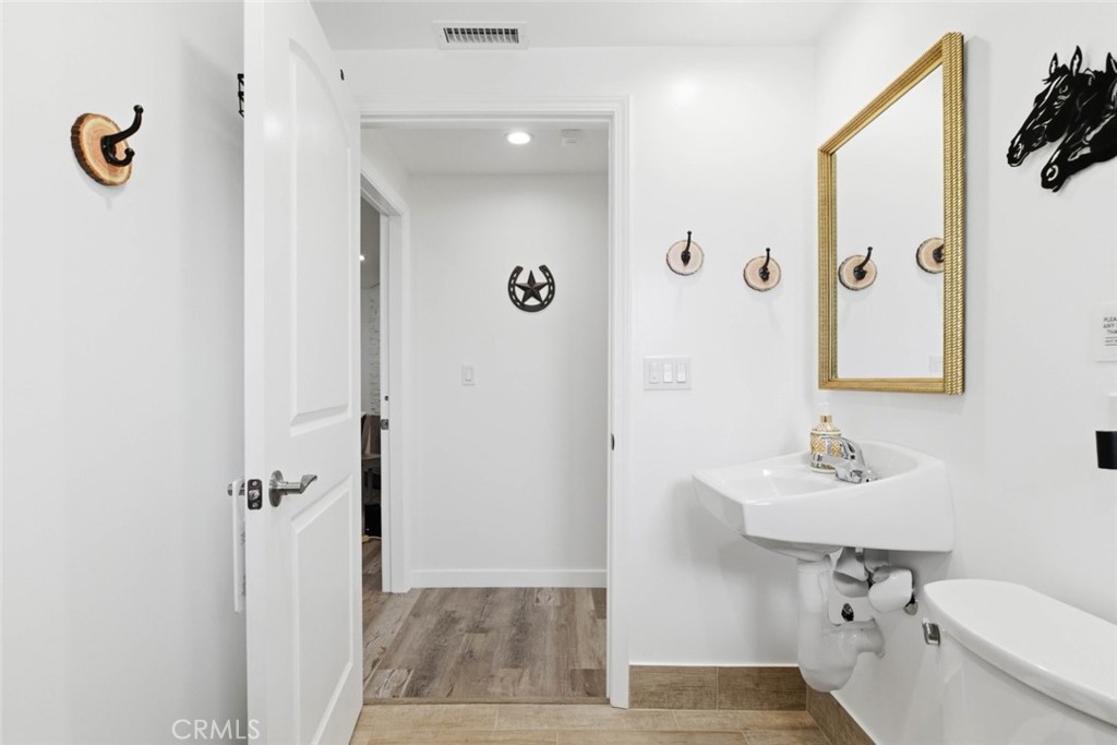 301 West Ashby Street Azusa, CA 91702 - Photo 53 of 75 a bathroom with a sink a toilet a mirror and shower