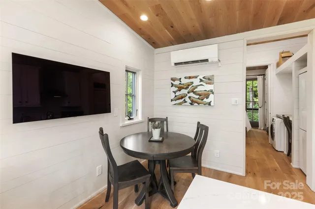 a dining room with furniture and wooden floor