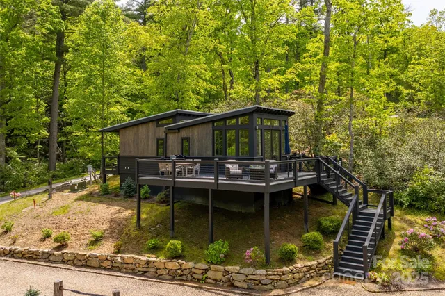 a view of house with swimming pool and sitting area