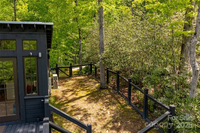 a view of a wooden fence and trees