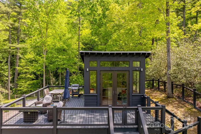 a view of house with roof deck and couches