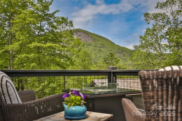 a view of a chairs and table in the roof deck