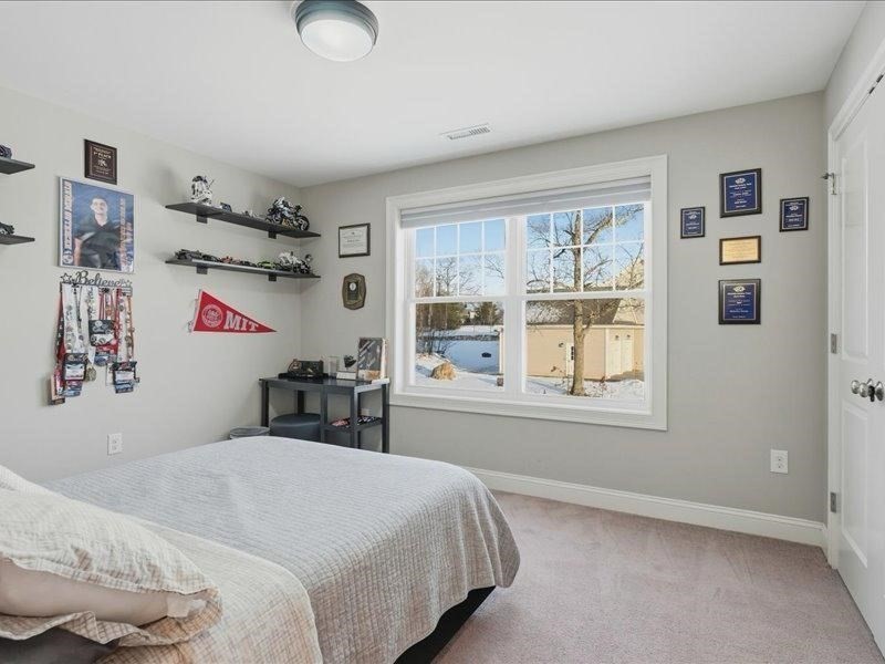 2 Aspen Drive Pelham, NH 03076 - Photo 32 of 42 a bedroom with a bed and a window