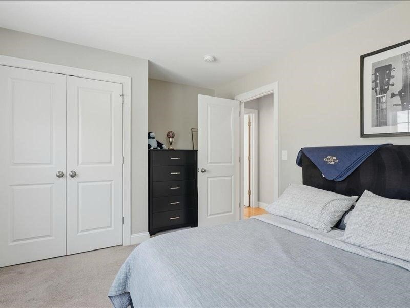 2 Aspen Drive Pelham, NH 03076 - Photo 33 of 42 a bedroom with a bed and a painting on the wall