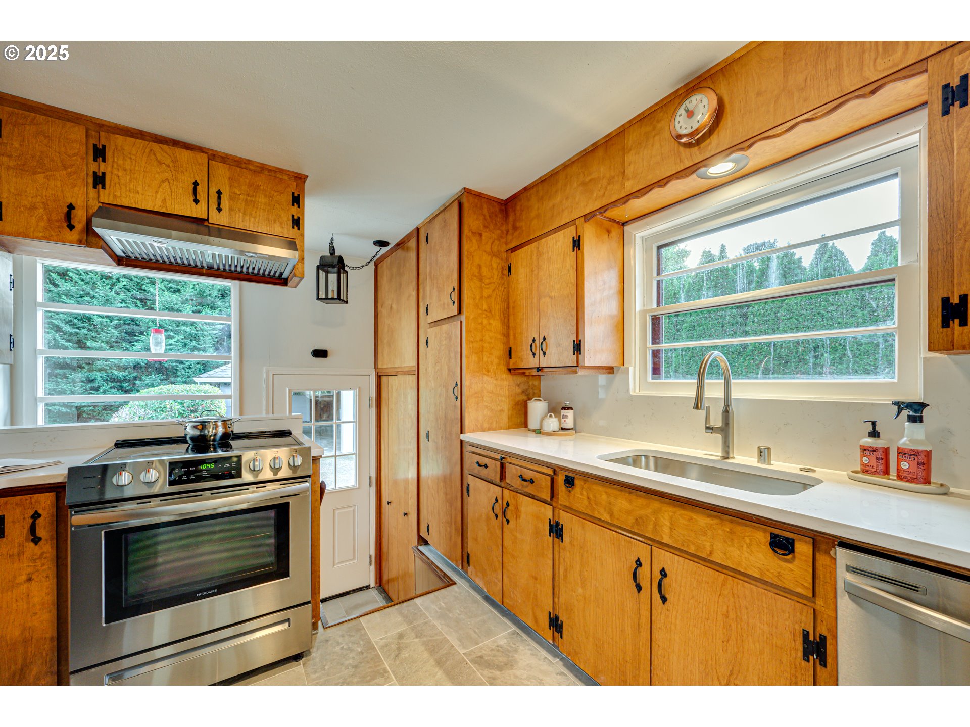 222 Northwest 19th Avenue Camas, WA 98607 - Photo 12 of 42 a kitchen with stainless steel appliances a stove a sink and a microwave
