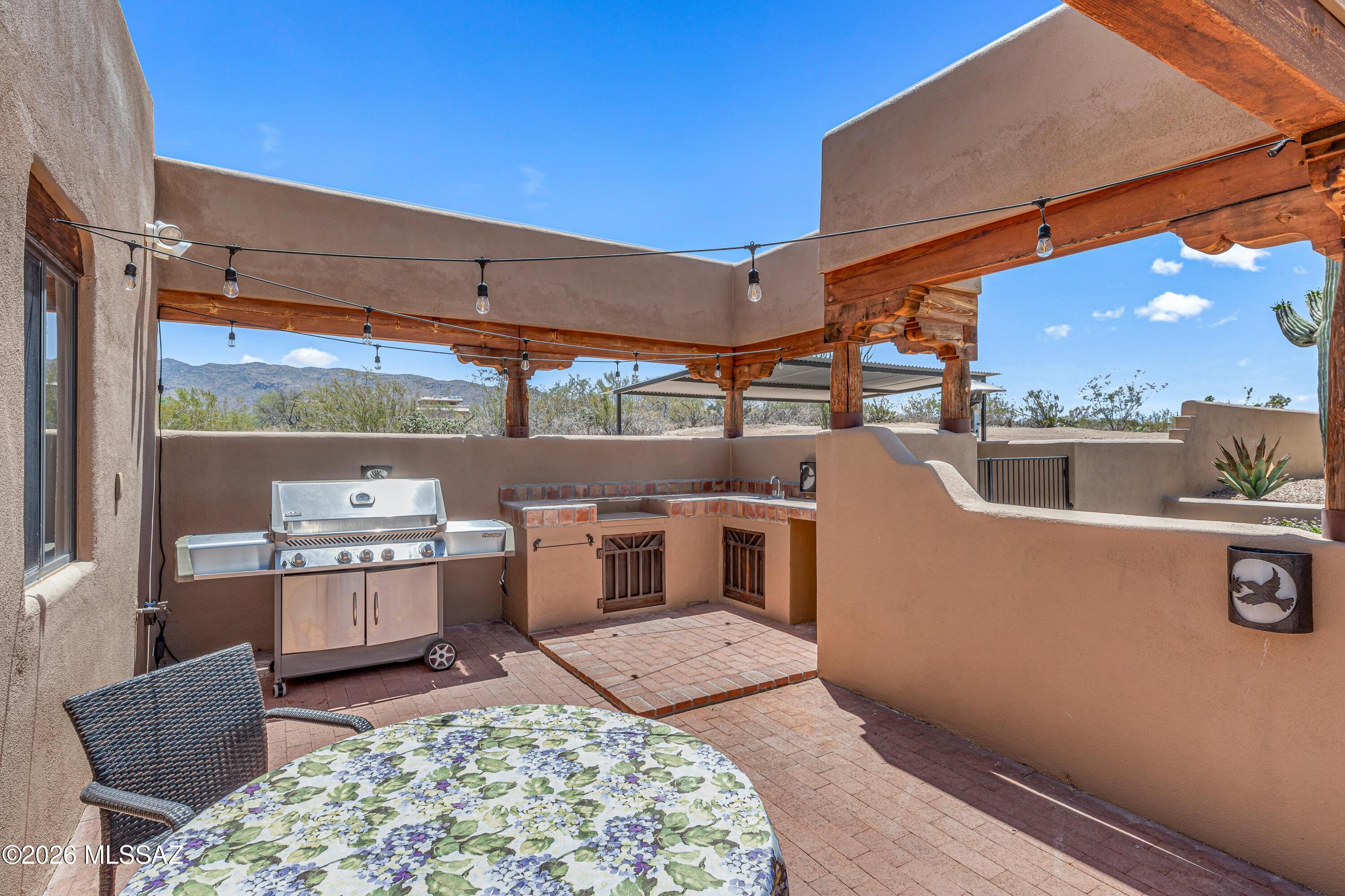 11160 East Golf Links Road Tucson, AZ 85730 - Photo 30 of 51 Outdoor kitchen area with party lights.