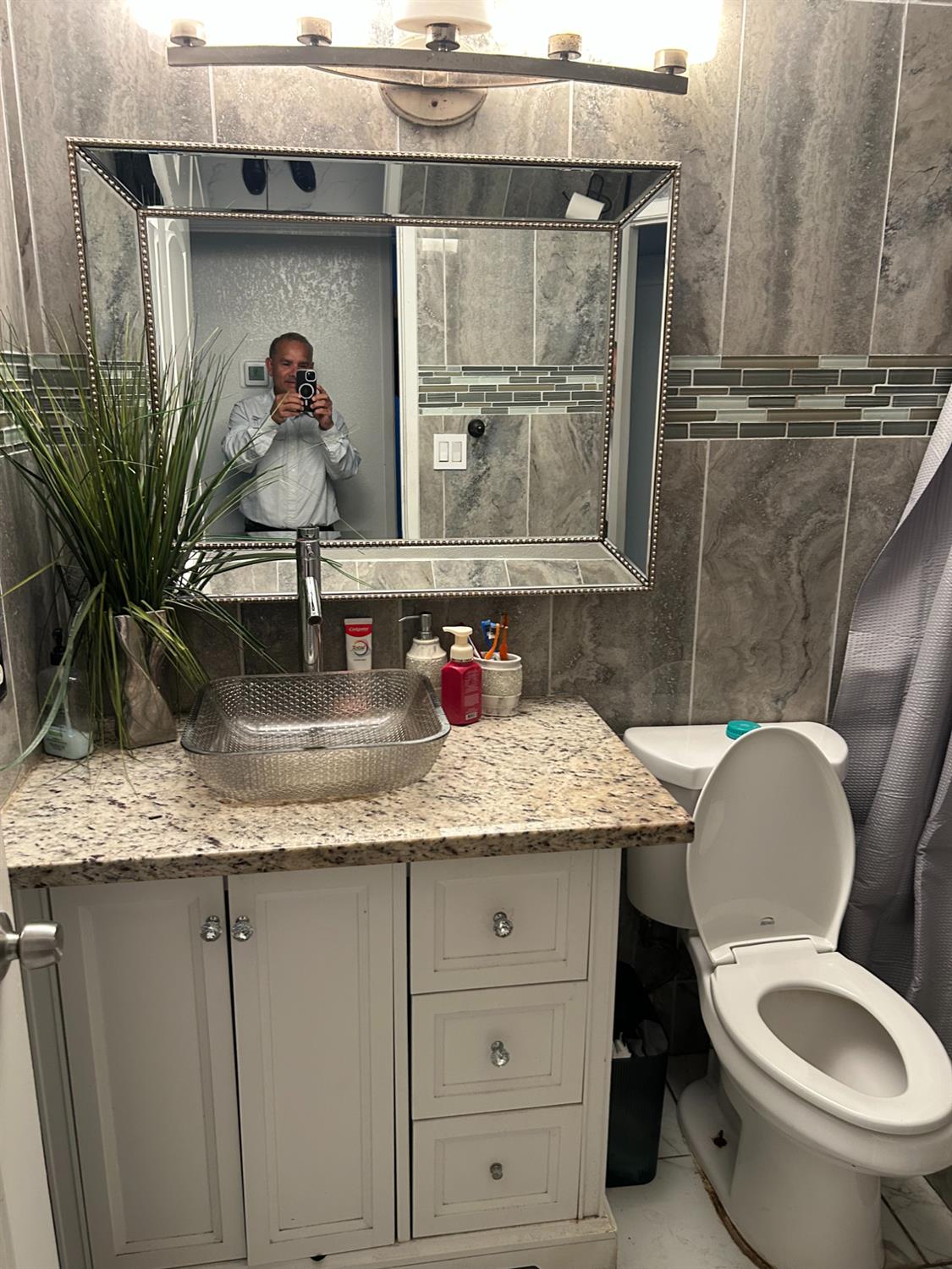 629 E Fort Modesto, CA 95354 - Photo 12 of 16 a bathroom with a granite countertop toilet sink and mirror