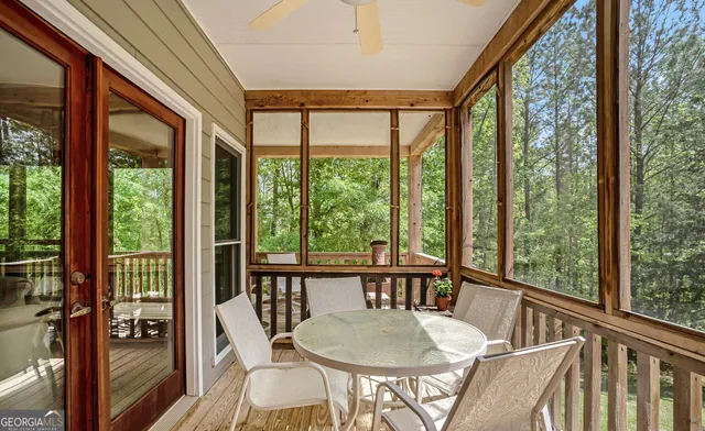 a view of balcony with chairs and wooden fence