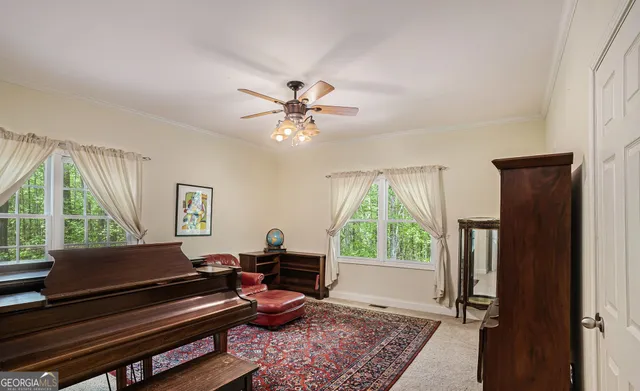an empty room with a window and a ceiling fan