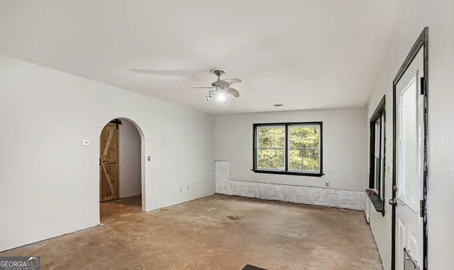 a view of room with window and ceiling fan